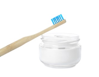 Photo of Bamboo toothbrush and bowl with baking soda on white background