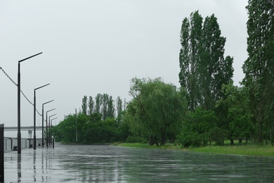 Photo of Empty city embankment under heavy rain on spring day