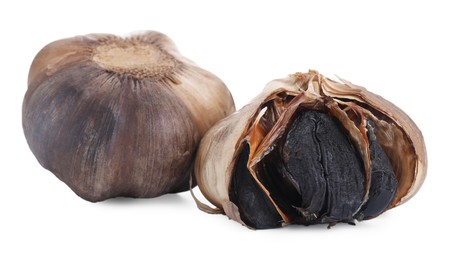 Photo of Bulbs of fermented black garlic isolated on white
