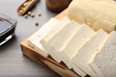 Photo of Natural tofu on wooden table, closeup. Soy product