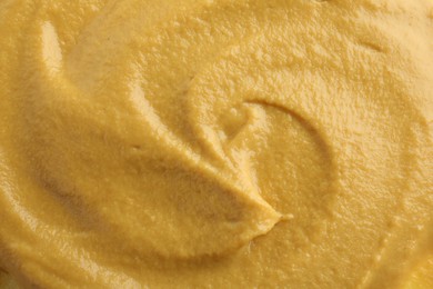 Photo of Fresh tasty mustard sauce as background, top view