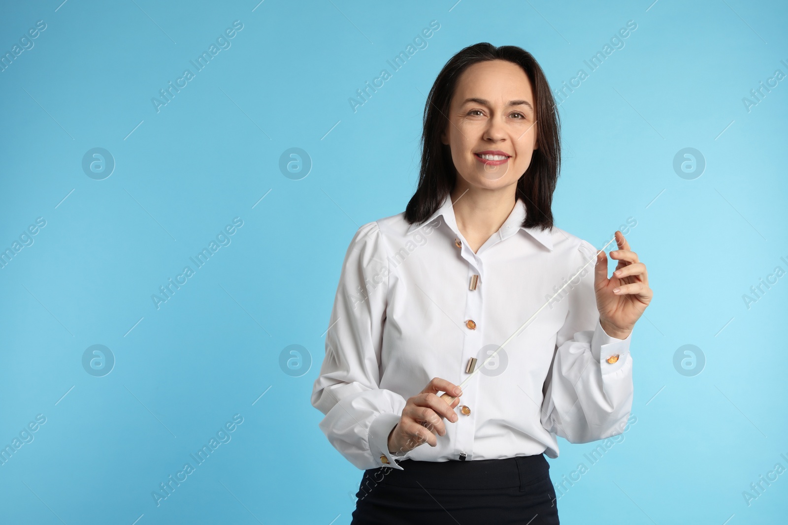 Photo of Music teacher with baton on turquoise background