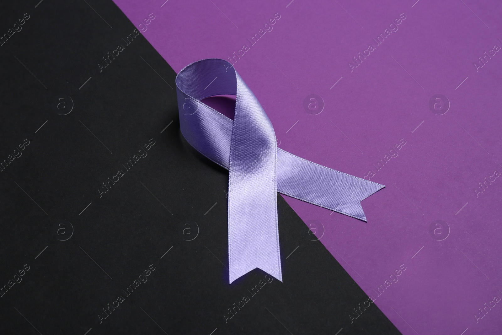 Photo of Satin purple awareness ribbon on color background