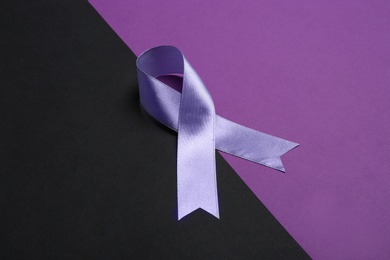 Satin purple awareness ribbon on color background