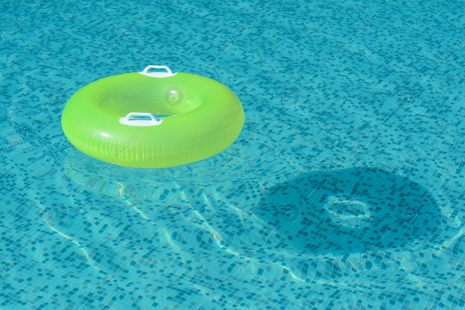 Photo of Light green inflatable ring floating in swimming pool. space for text