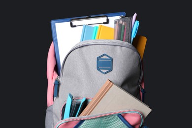 Photo of Backpack with different school stationery near blackboard, space for text
