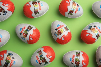 Photo of Sveti Vlas, Bulgaria - June 26, 2023: Kinder Surprise Eggs on light green background, flat lay