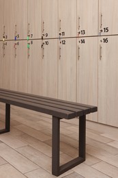 Photo of Wooden bench near lockers in changing room