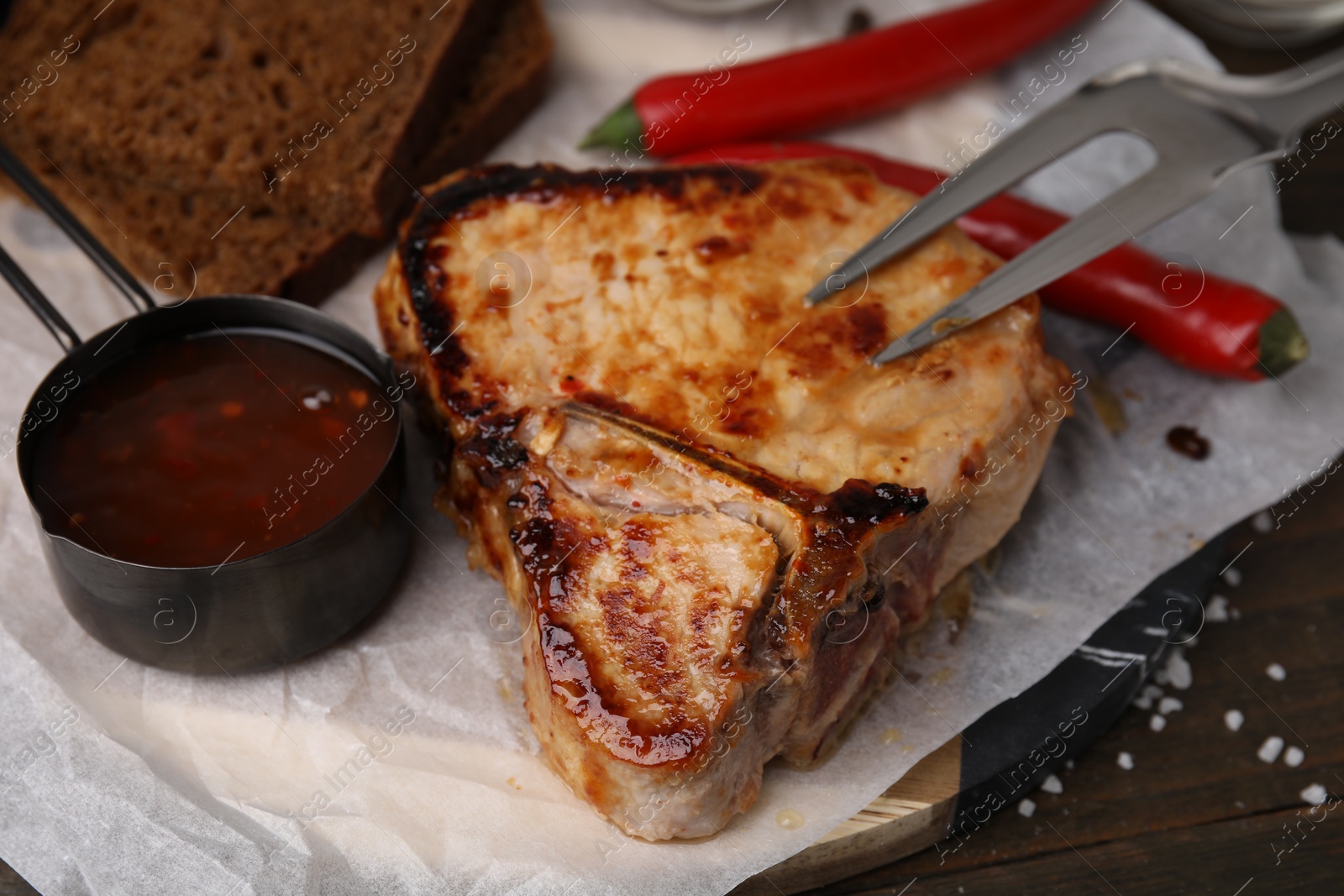 Photo of Tasty grilled meat, chili and marinade on table, closeup