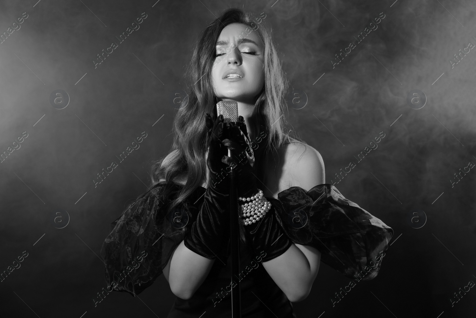 Image of Beautiful singer with microphone, black and white effect