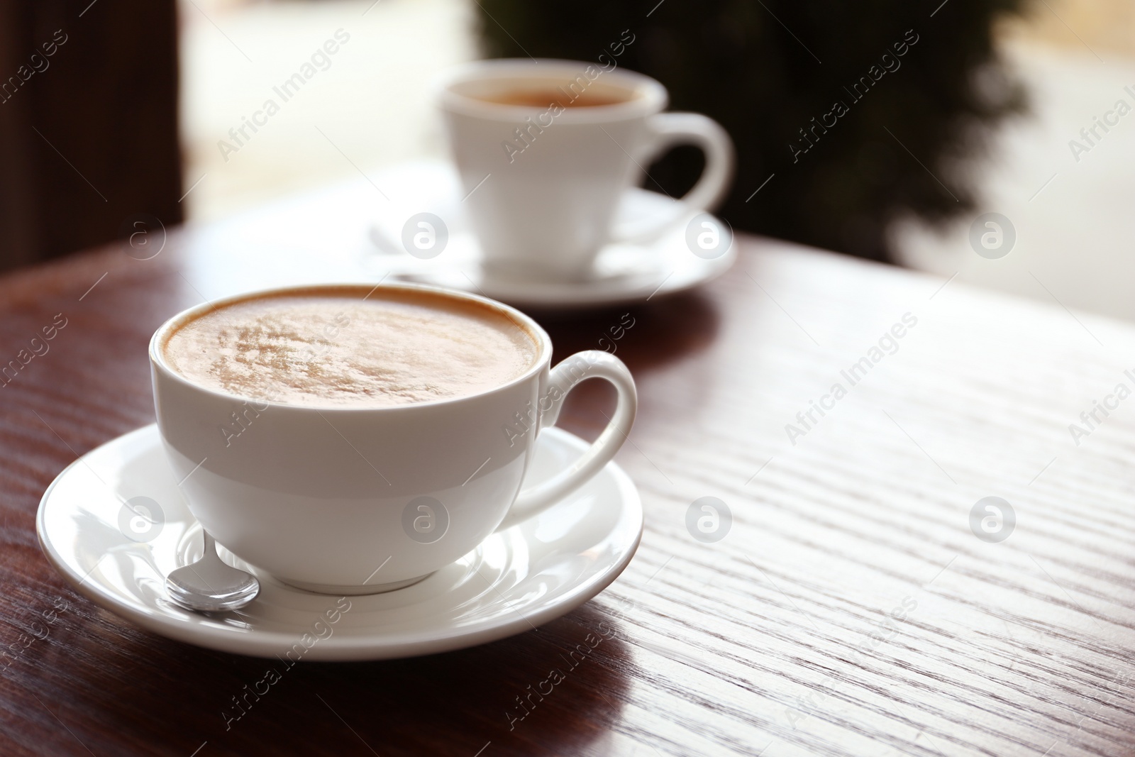 Photo of Cup of delicious aromatic coffee on table