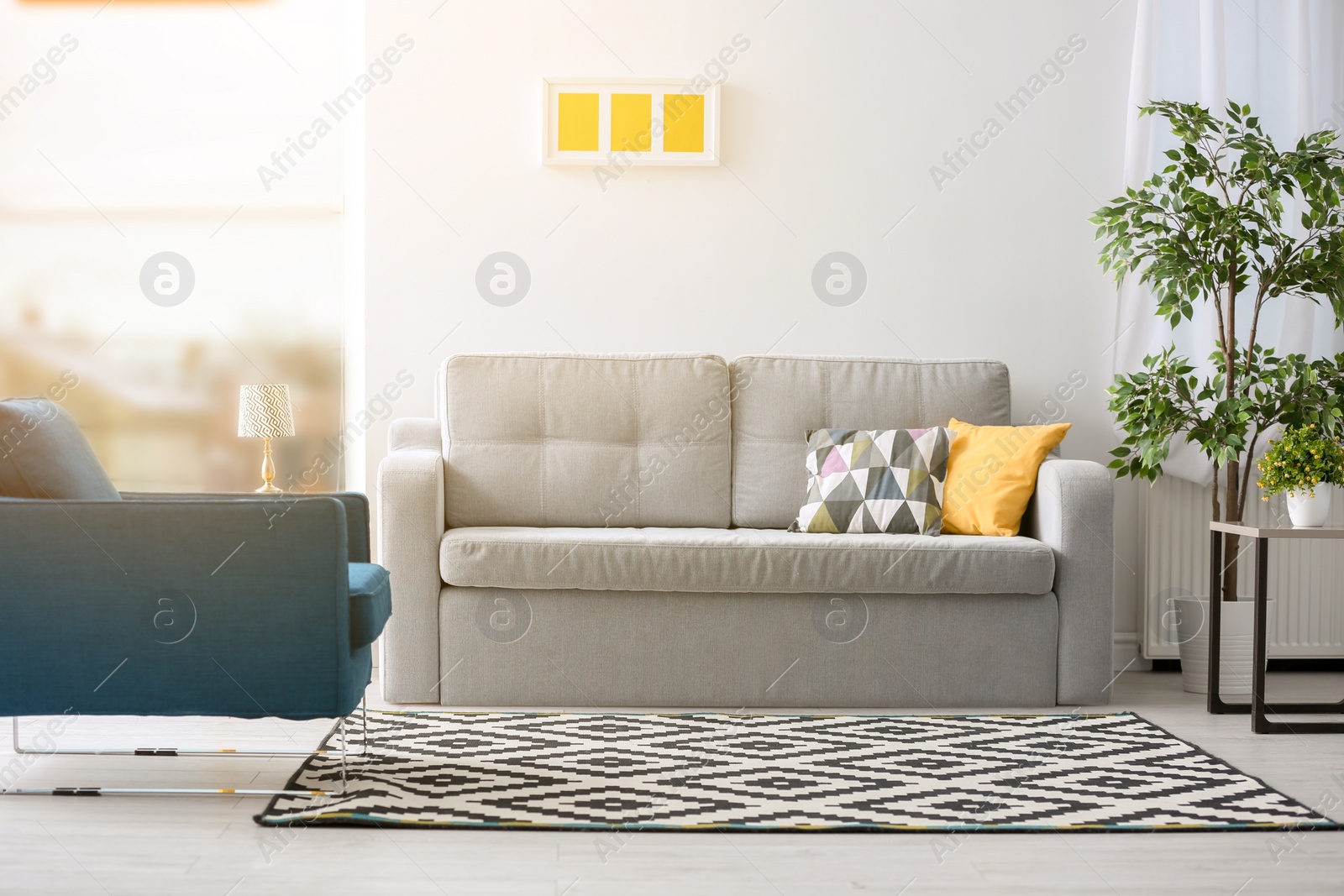 Photo of Stylish living room interior with comfortable sofa and armchair