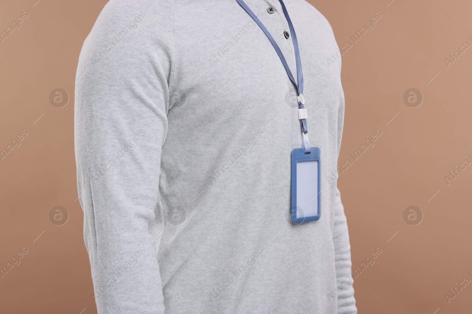 Photo of Man with blank badge on beige background, closeup