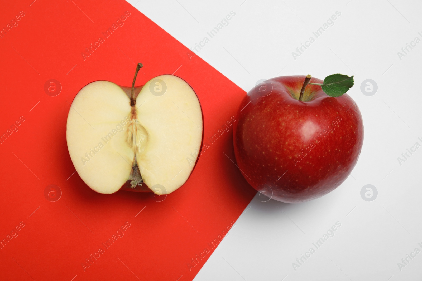 Photo of Flat lay composition with ripe juicy red apples on color background