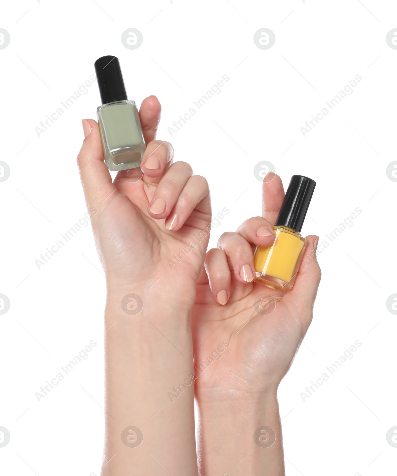 Photo of Woman holding nail polishes on white background, closeup