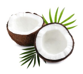 Photo of Halves of fresh ripe coconut with green leaves on white background