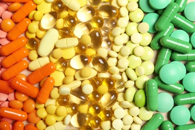 Photo of Different colorful pills as background, top view