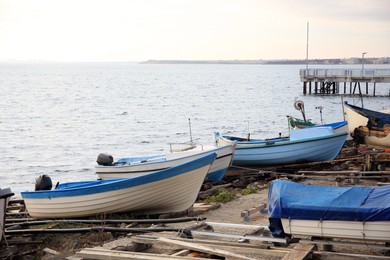 Moored boats on beach near sea outdoors