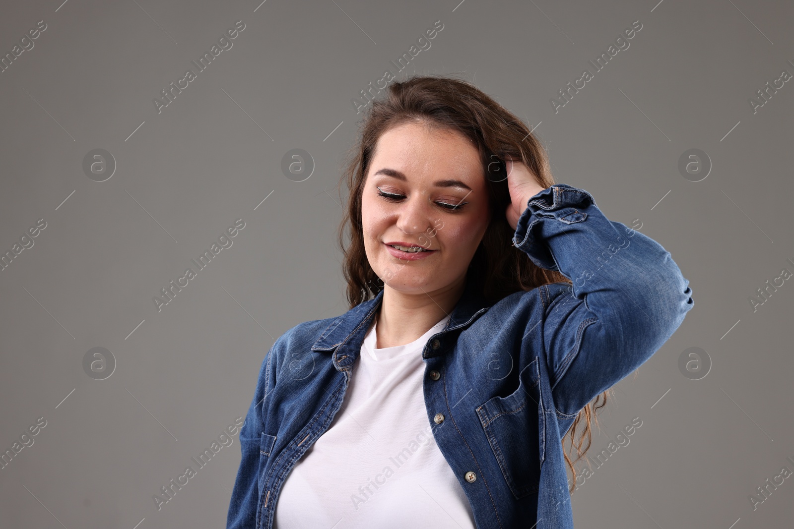 Photo of Portrait of beautiful young woman on grey background