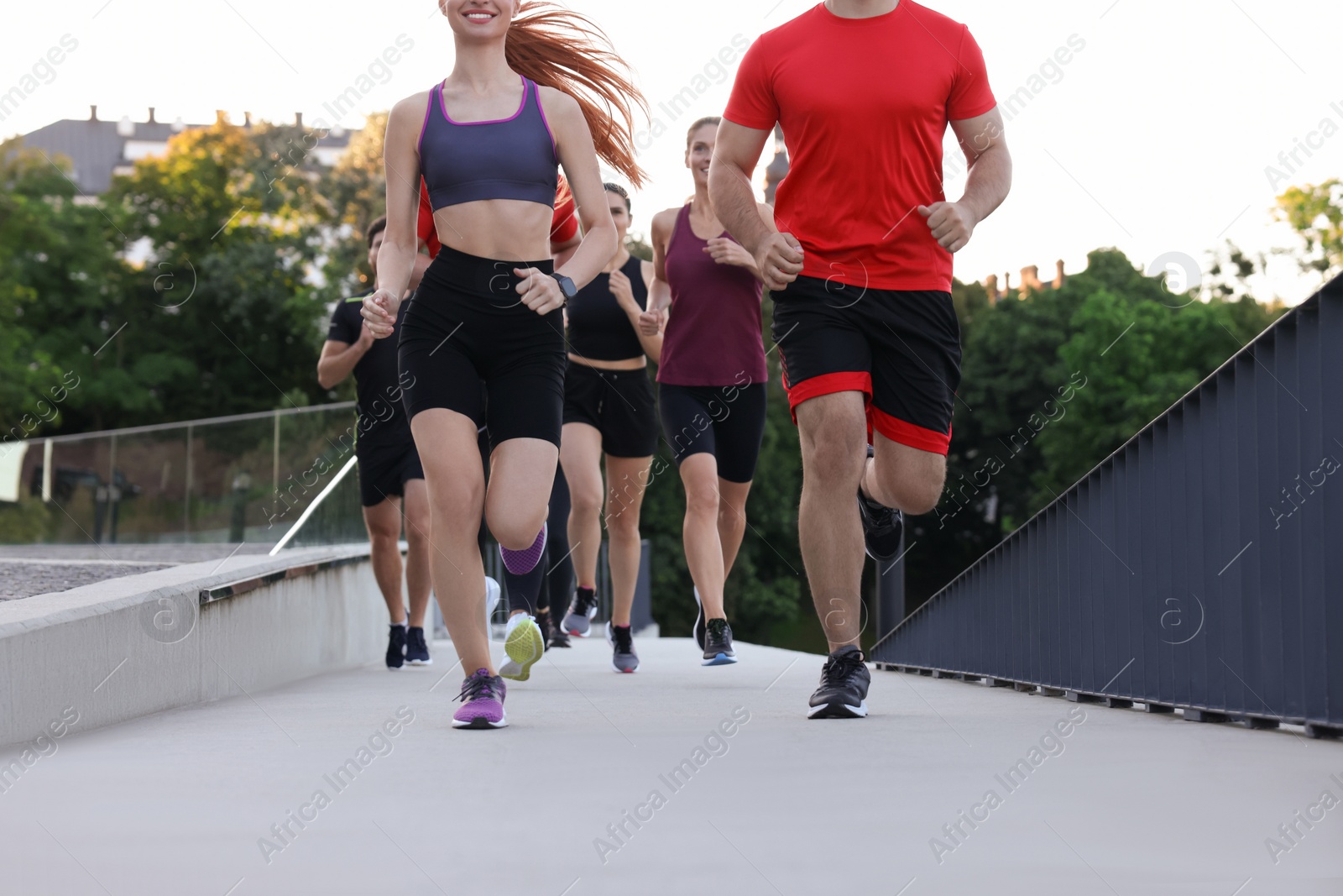 Photo of Group of people running outdoors. Active lifestyle