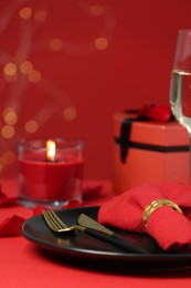 Beautiful table setting with burning candle for romantic dinner, closeup