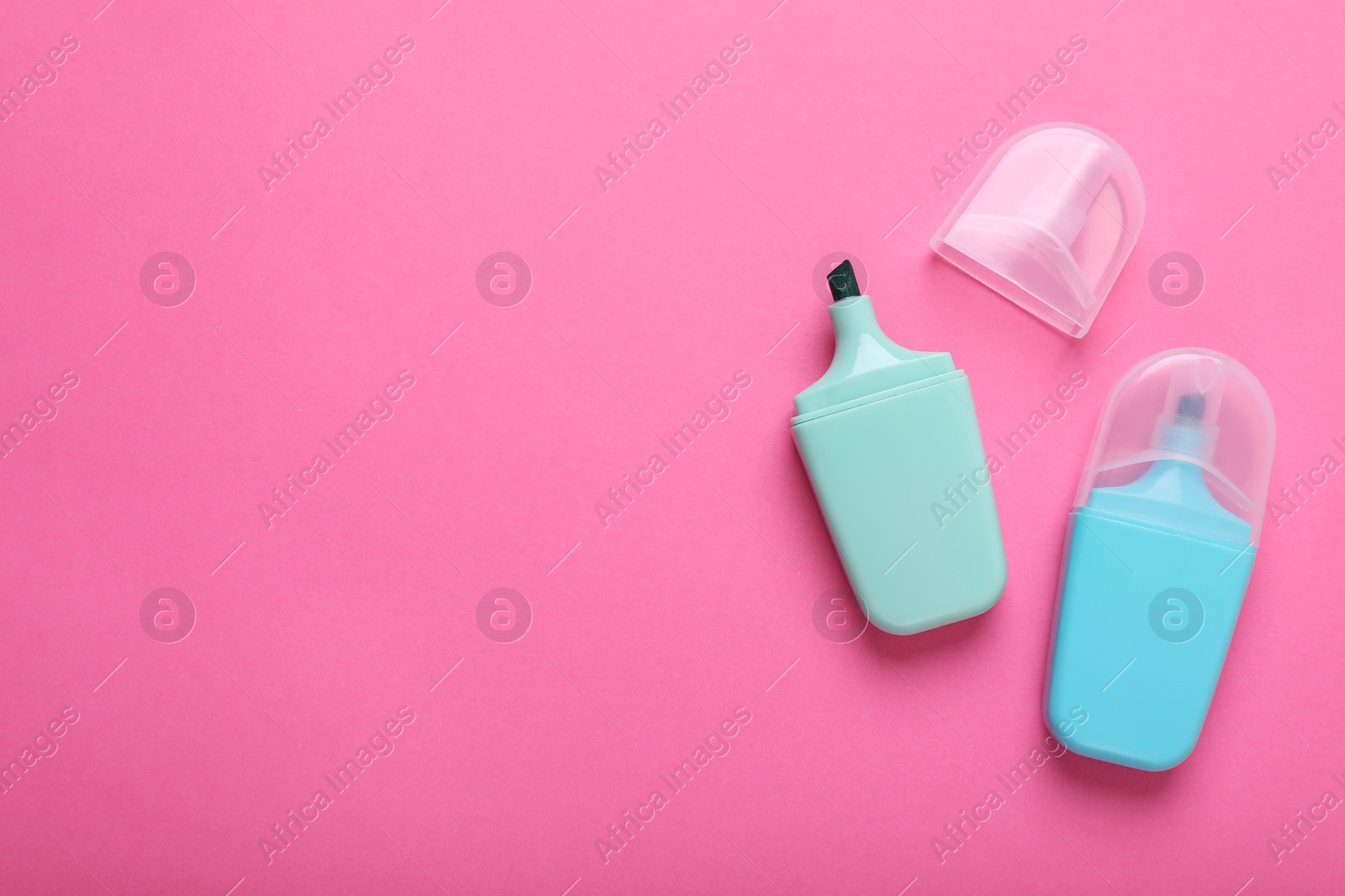 Photo of Colorful markers on pink background, flat lay. Space for text