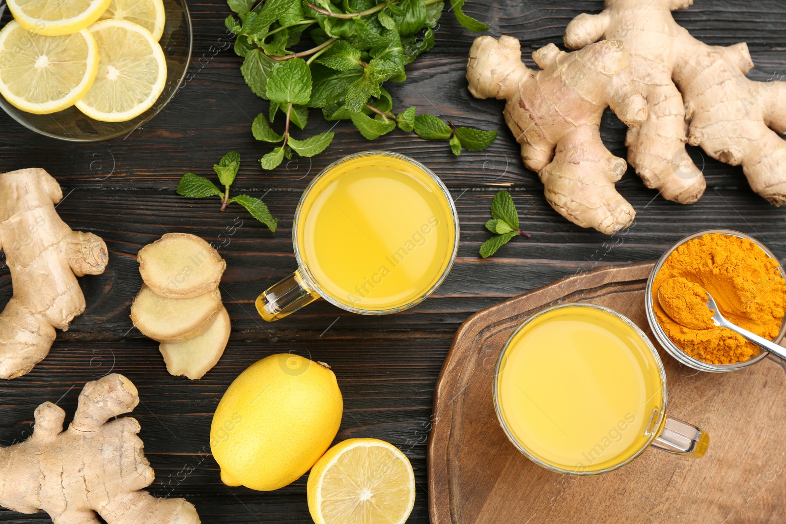 Photo of Flat lay composition with immunity boosting drink and ingredients on dark wooden table