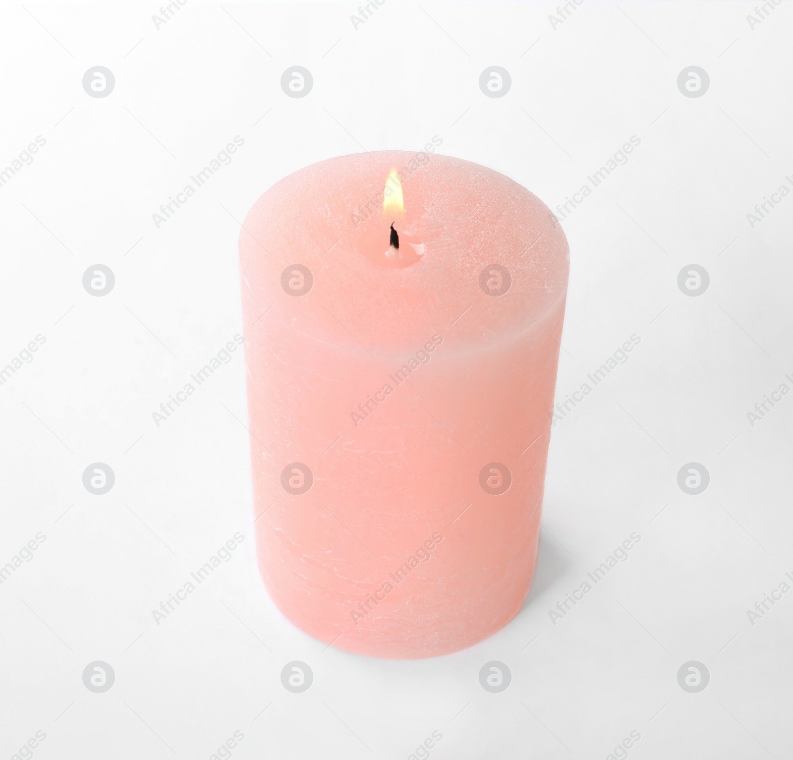 Photo of Burning pink wax candle isolated on white