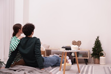 Couple watching movie via video projector at home