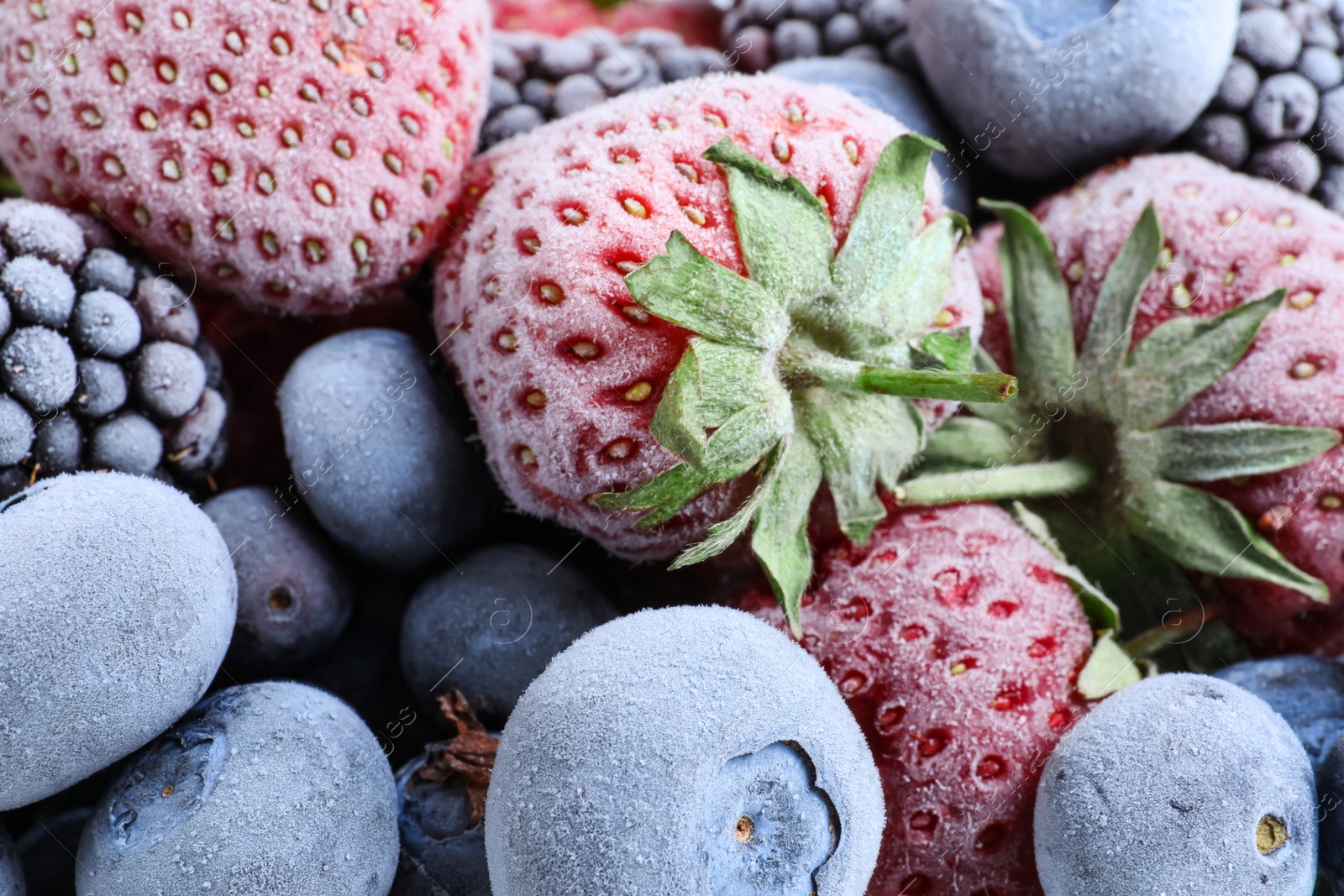 Photo of Mix of different frozen berries as background, top view