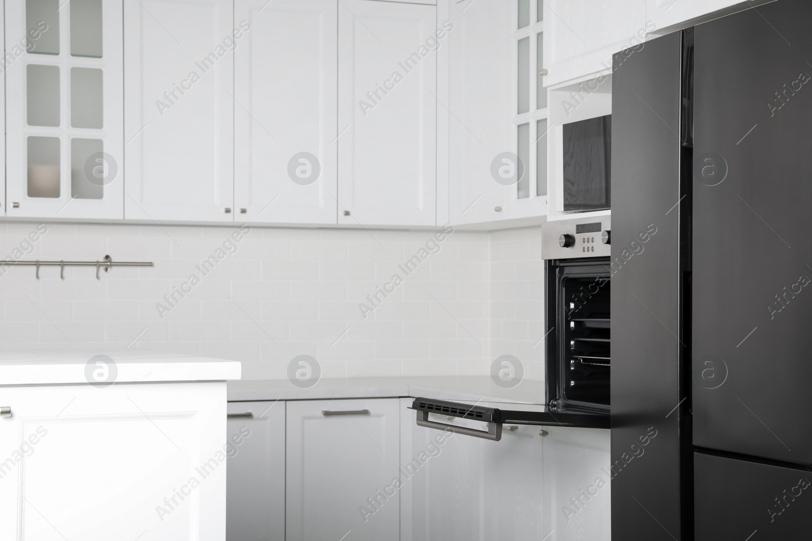 Photo of Modern oven and microwave in white clean kitchen