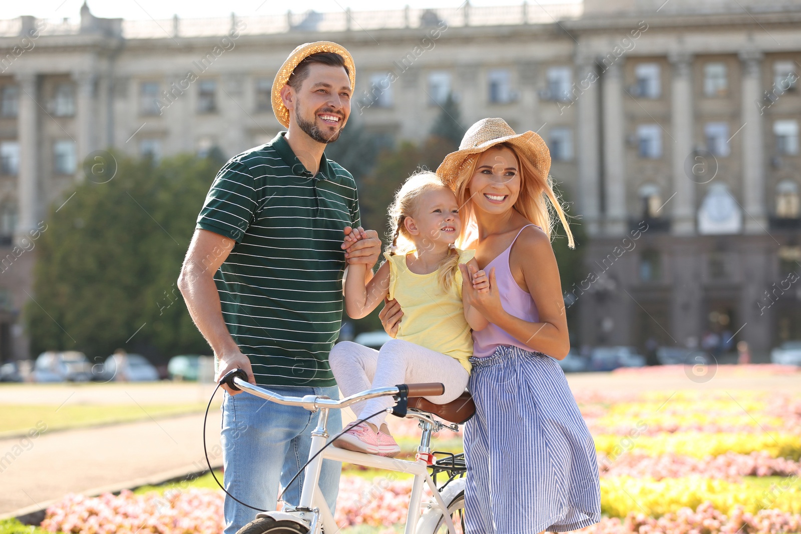 Photo of Happy family with bicycle outdoors on summer day