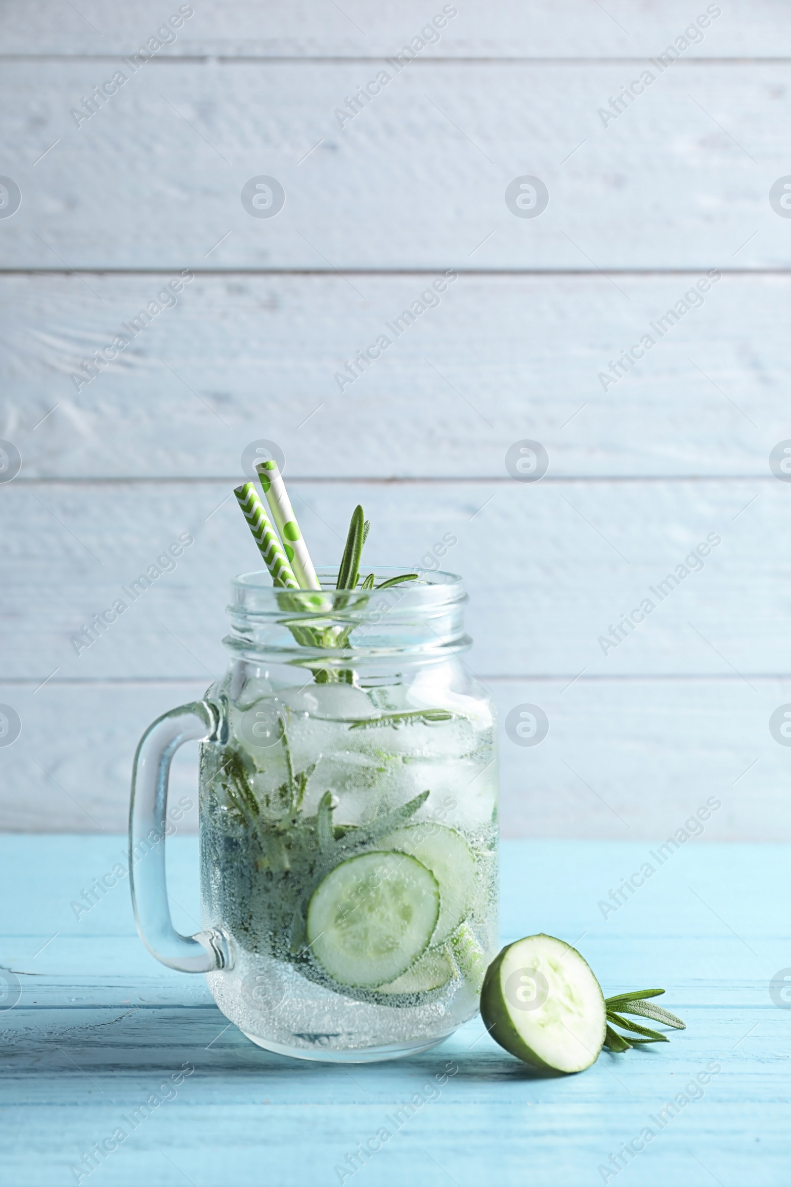 Photo of Natural lemonade with cucumber in mason jar on wooden table