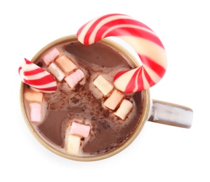 Photo of Cup of tasty cocoa with marshmallows and Christmas candy cane isolated on white, top view