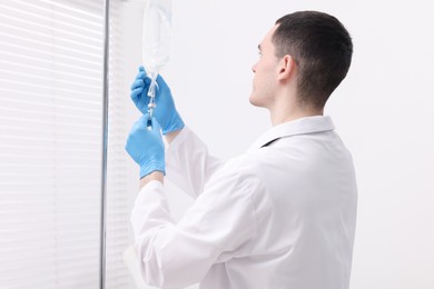 Photo of Doctor setting up IV drip in hospital