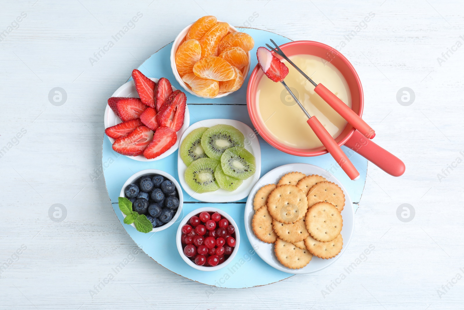 Photo of Flat lay composition with white chocolate fondue on wooden background