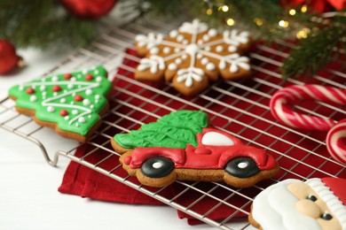 Photo of Tasty homemade Christmas cookies and candy canes on white wooden table, closeup