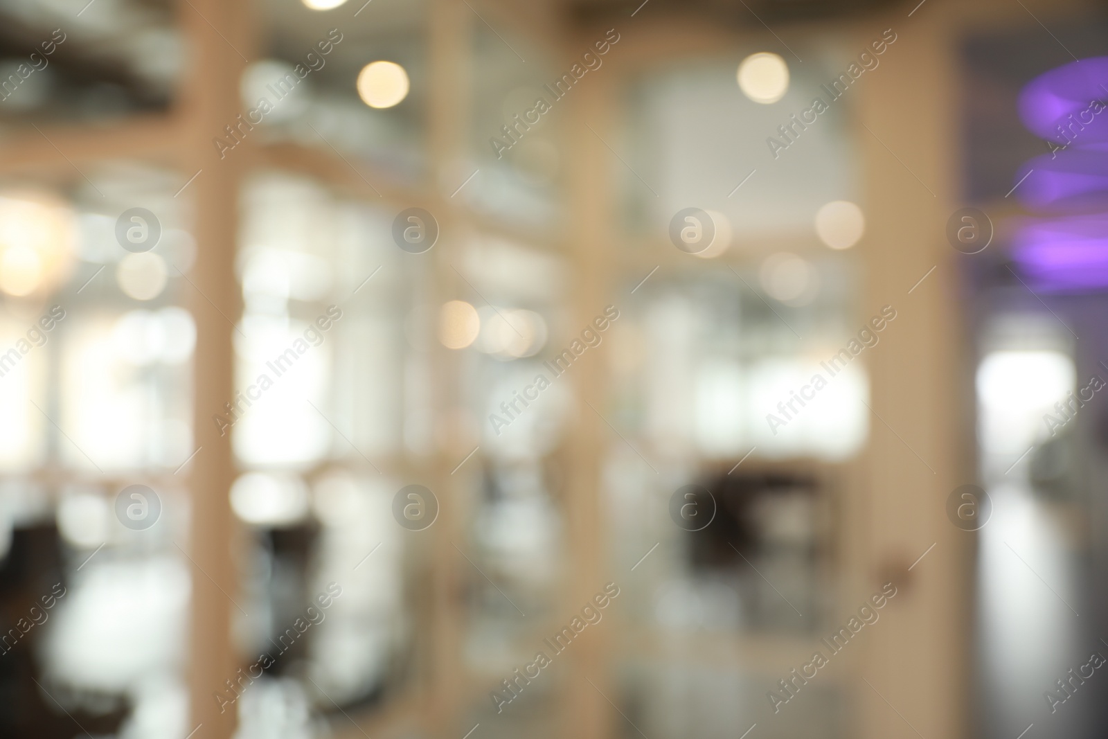 Photo of Blurred view of empty conference room and glass door in office