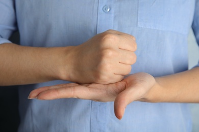 Photo of Woman showing hand sign, closeup. Body language