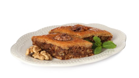 Photo of Plate of delicious honey baklava with walnuts on white background