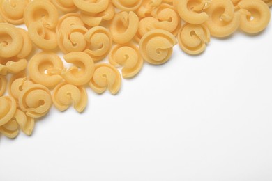 Raw dischi volanti pasta on white background, top view. Space for text