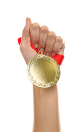 Woman holding golden medal on white background, closeup. Space for design
