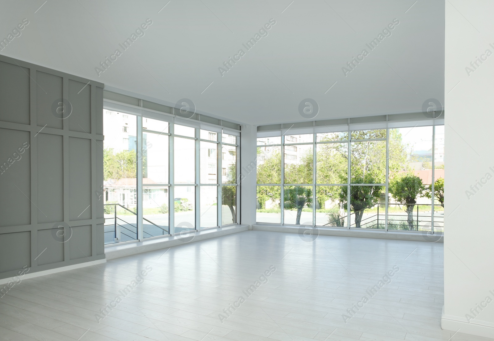 Photo of Empty room with large windows and laminated floor