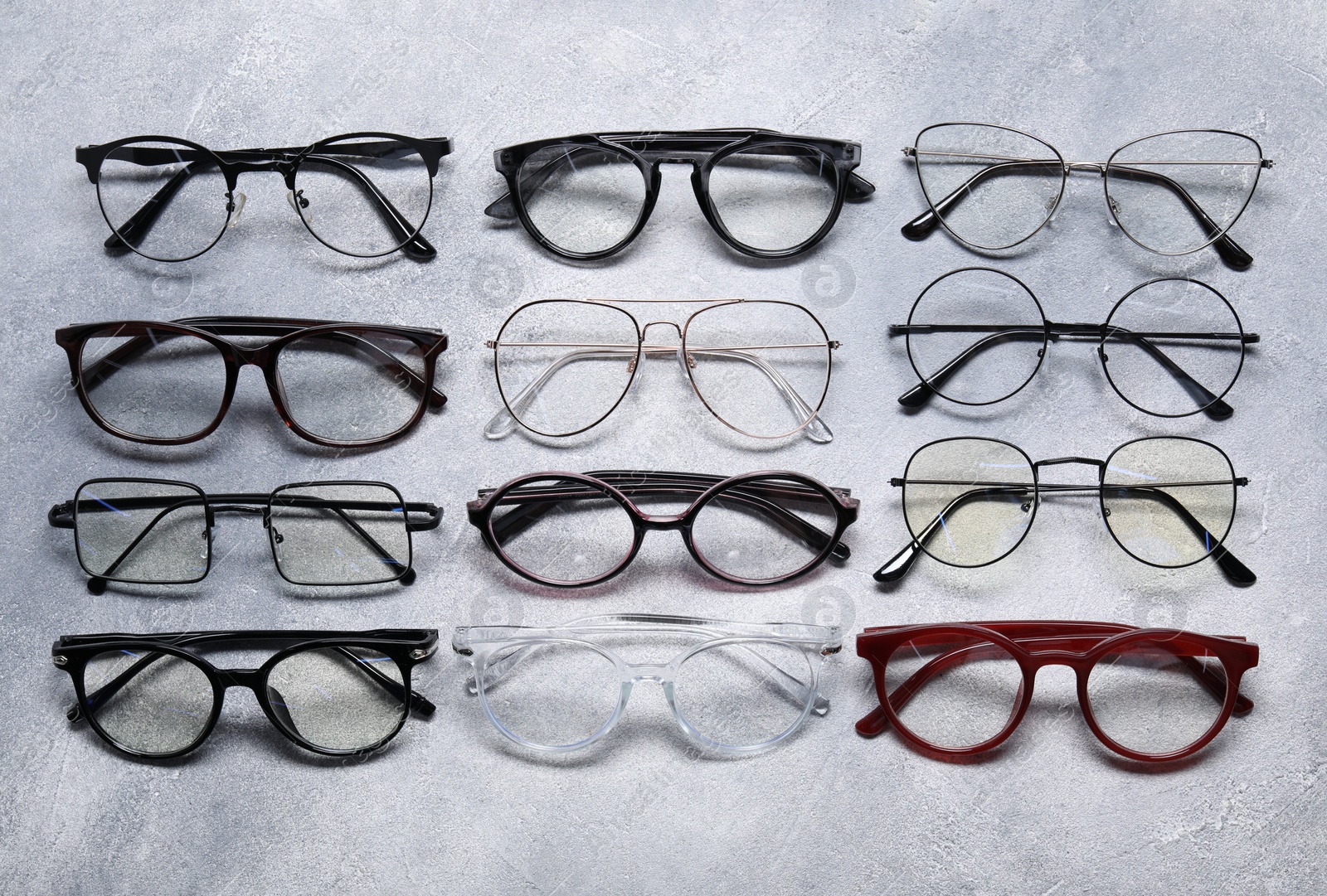 Photo of Many different glasses on light grey background, flat lay