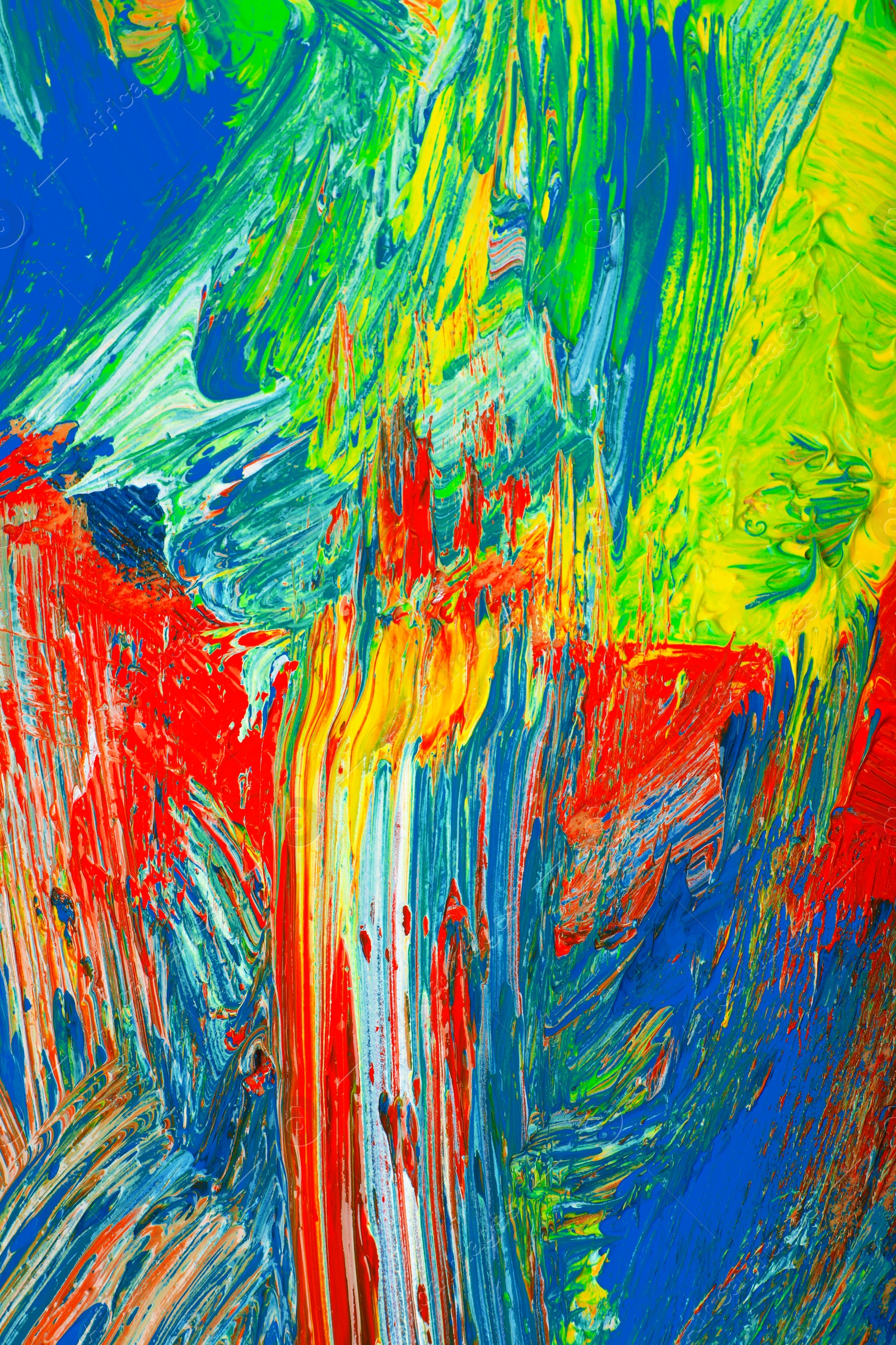 Photo of Closeup view of artist's palette with mixed bright paints as background