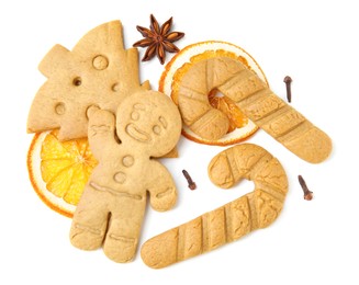 Different tasty cookies and spices on white background, top view