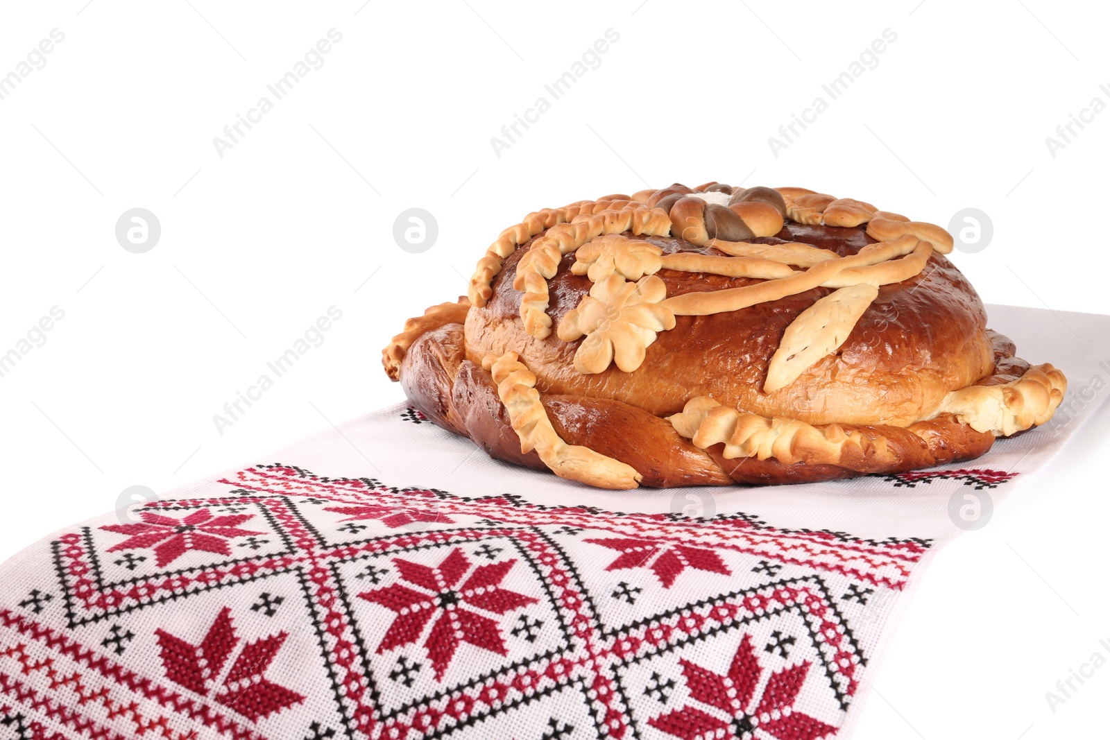 Photo of Rushnyk with korovai on white background. Ukrainian bread and salt welcoming tradition