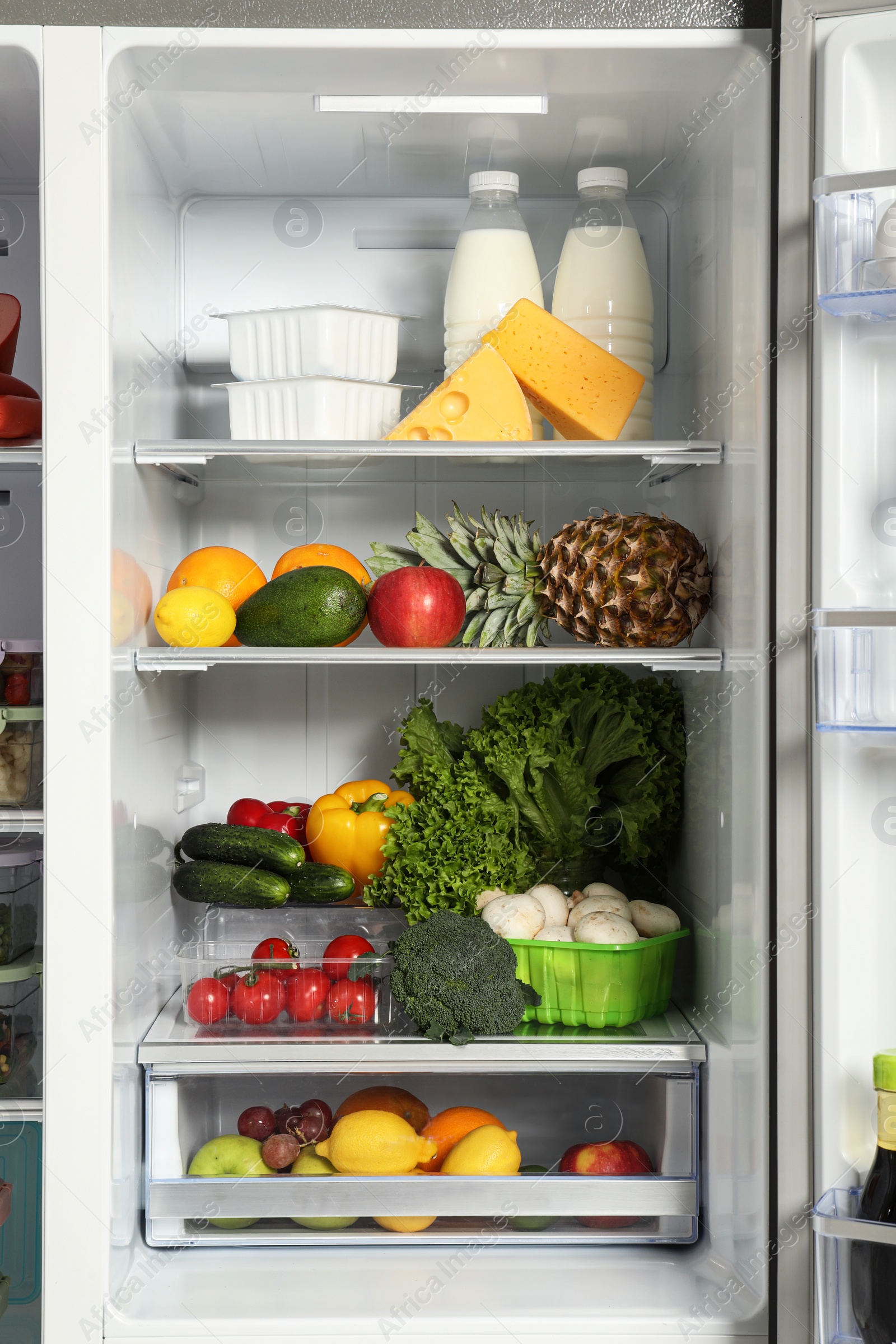 Photo of Open refrigerator full of different fresh products