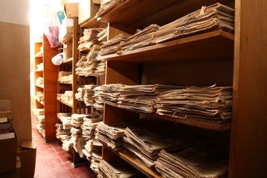 Photo of Collection of old newspapers on shelves in library