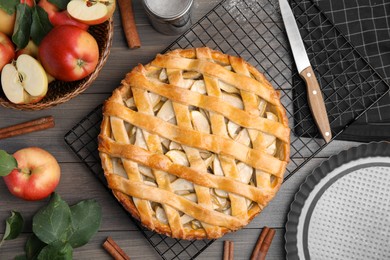 Delicious traditional apple pie on wooden table, flat lay